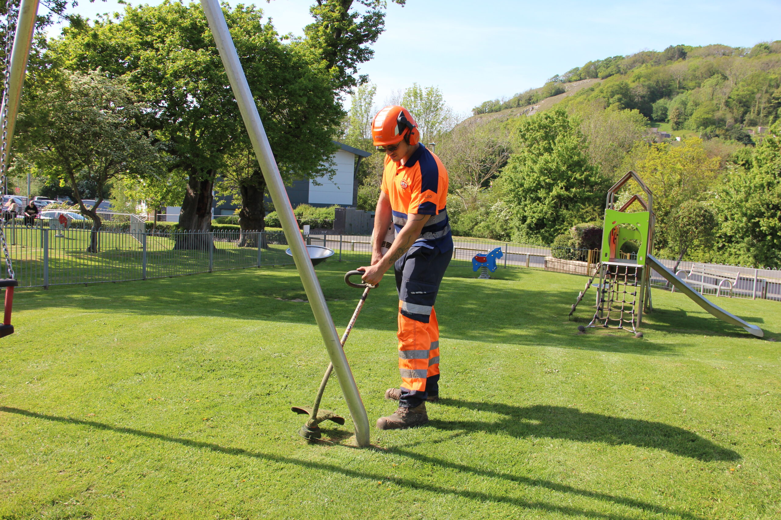 Grass strimming in a playground