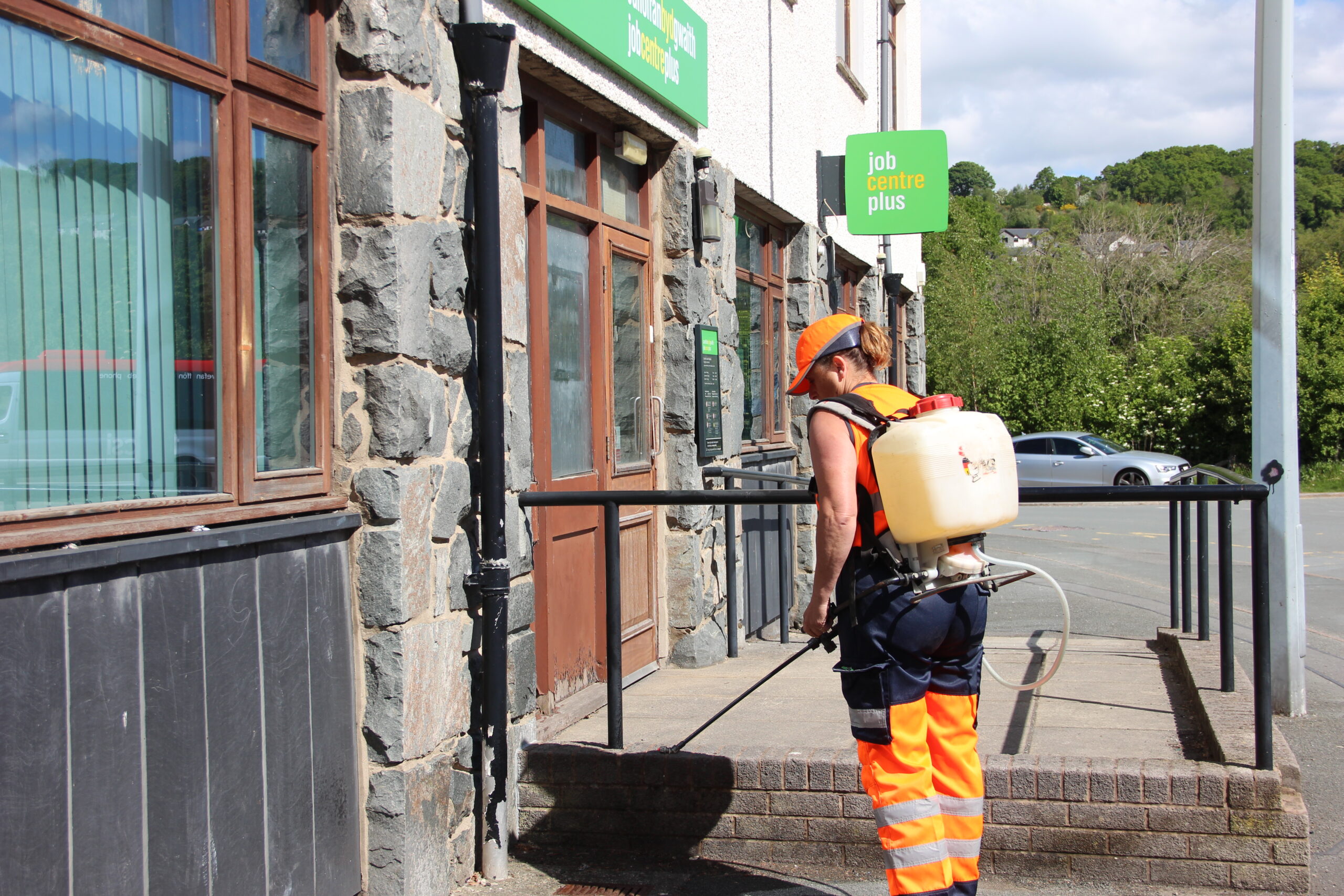 Spraying weedkiller at a commercial building