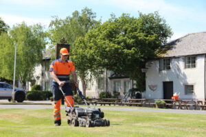 Cutting the lawn at a public house